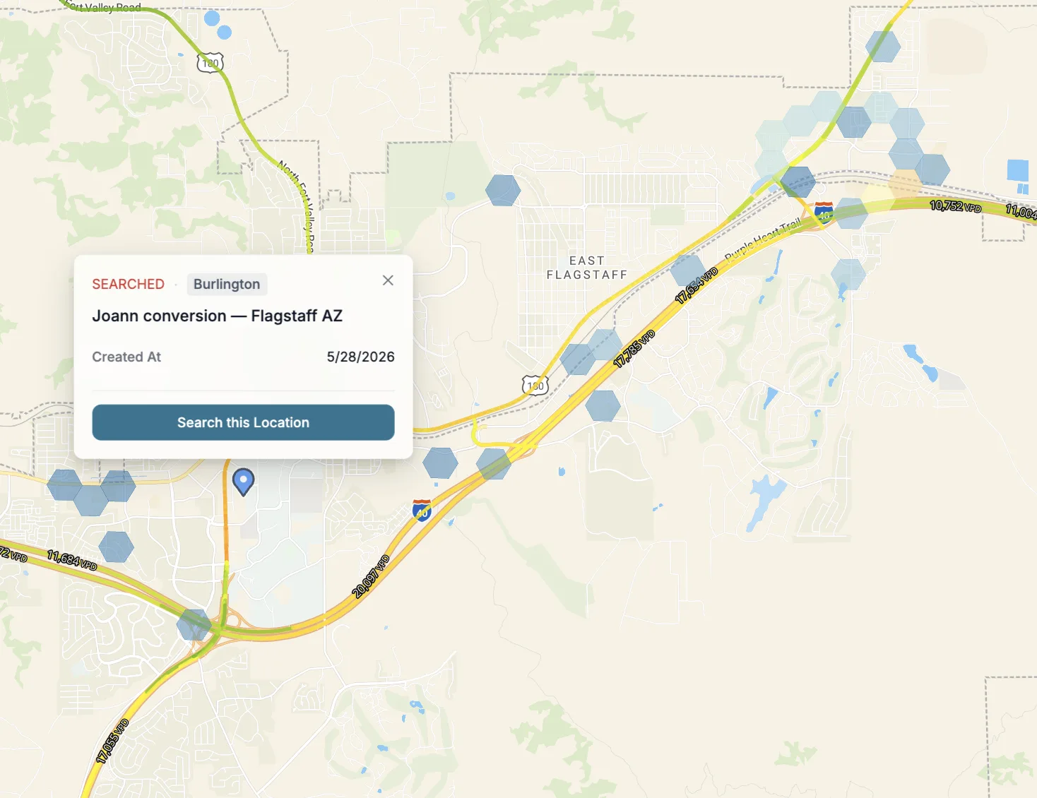 Flagstaff, AZ. The conversion (blue pin) sits next to a cluster of cool hexagons. The chain's portfolio profile does not index this corridor high.